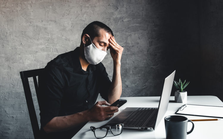 A man Bored during quarantine at the computer. Pandemic epidemic